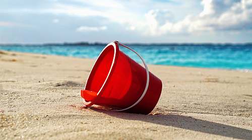 cabbage beach red plastic bucket on seashore paradise island